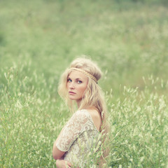 Naklejka na ściany i meble beautiful young girl in a meadow in spring