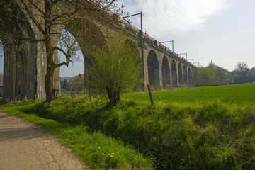 Railroad over a viaduct through a sunny countryside