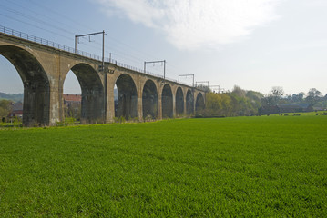 Railroad over a viaduct through a sunny countryside