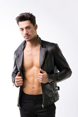 Attractive young man with leather jacket on naked torso