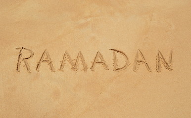 Text 'Ramadan' in the sand