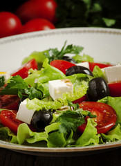 salad with tomatoes, olives and cheese, selective focus