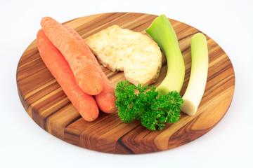 Mirepoix on wooden cutting board with white background