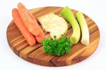 Mirepoix on wooden cutting board with white background