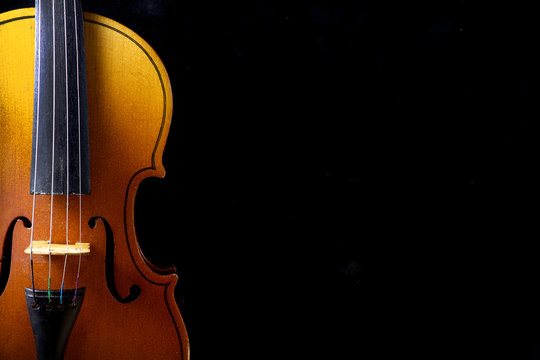 Close up of a violin isolated on black