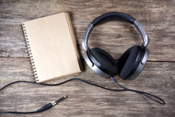 Vintage Headphones and paper note on wood