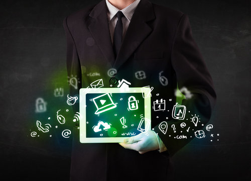 Person holding tablet with green media icons and symbols