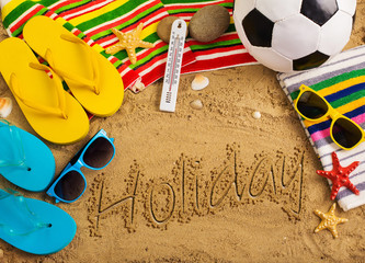 Summer concept of sandy beach, colorful flip flop shoes, sunglas