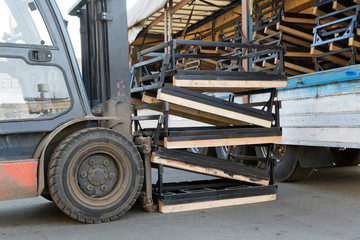 Fototapeta na wymiar Factory Forklift Stacker loading Cargo into Truck Trailer