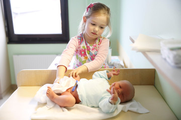 Fototapeta premium Sister with her newborn brother