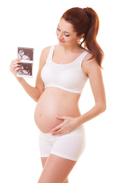 Pretty pregnant woman holding ultrasound scan. Isolated on white