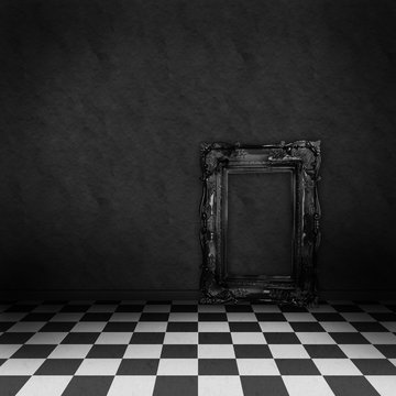 Room with black and white checker floor and empty frame