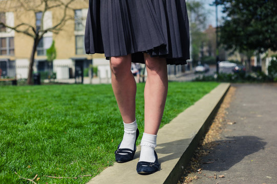 Woman wearing a skirt walking in park