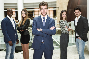 Fototapeta premium Businessman leader with arms crossed in working environment