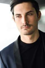 Obraz premium Attractive young businessman in urban background