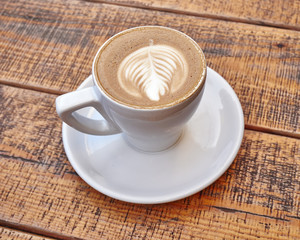 delicious art capuccino cup on wooden background
