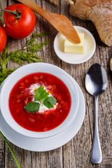 Tasty soup with bread on a wooden background.