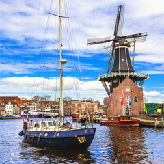 Fototapeta premium Holland, Haarlem' canals. windmill and sail boat