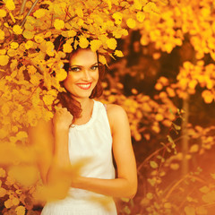 Beautiful woman in autumn park