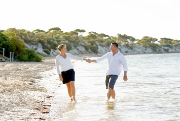 Fototapeta premium young couple in love walking on beach romantic summer holidays
