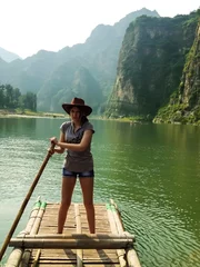 Foto op Canvas Pretty girl floating on a bamboo raft © ekaterina0290