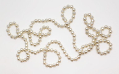 Beautiful necklace made of pearls on white background