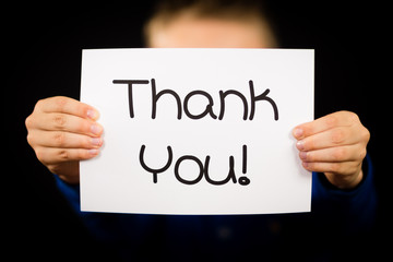 Child holding Thank You sign