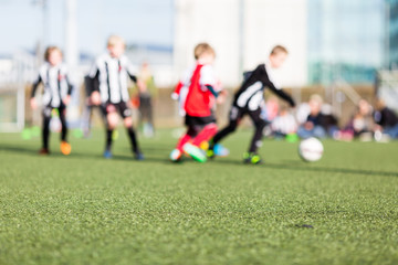 Obraz na płótnie Canvas Blur of boys playing soccer