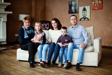 Obraz na płótnie Canvas Portrait of happy multigenerational family in sitting room at home