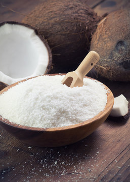close up of a coconut and grounded coconut flakes