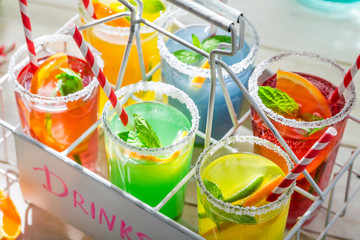 Tasty lemonade with straw and fruits