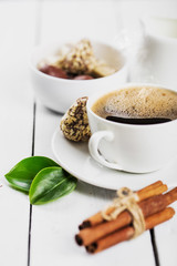 Hot cappuccino and pastries on white wooden boards