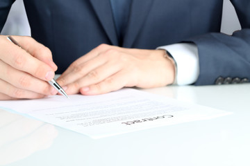Businessman is signing a contract, business contract details