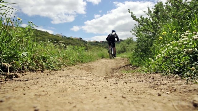 mountain bicycle riding through a country path
