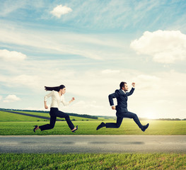 man and woman in formal wear running