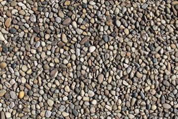 Pebbles-embedded stone texture as a background