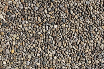 Pebbles-embedded stone texture as a background