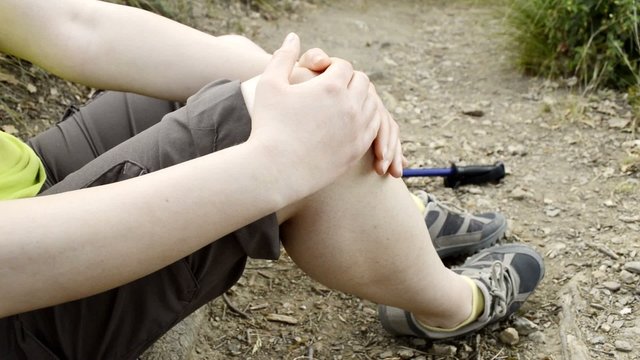 Hiker woman with knee pain in a fall