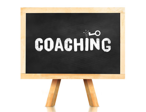 coaching word and key icon on blackboard with easel and reflecti