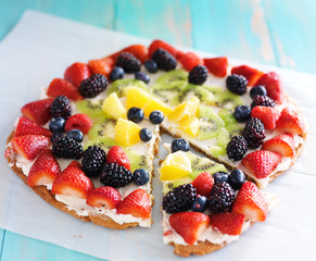 colorful fruit pizza with berries and cream cheese
