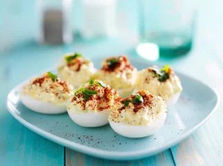 Foto op Plexiglas deviled eggs with paprika and green onion garnish © Joshua Resnick