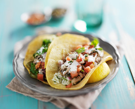 mexican authentic carnitas tacos with sour cream