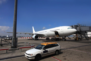 Fototapeta na wymiar Airplane near the terminal in an airport