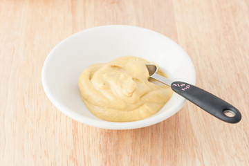 mustard on wooden background