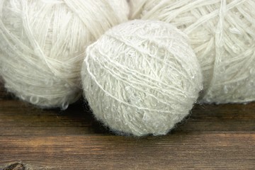 White Wool Rolls On Wood Background