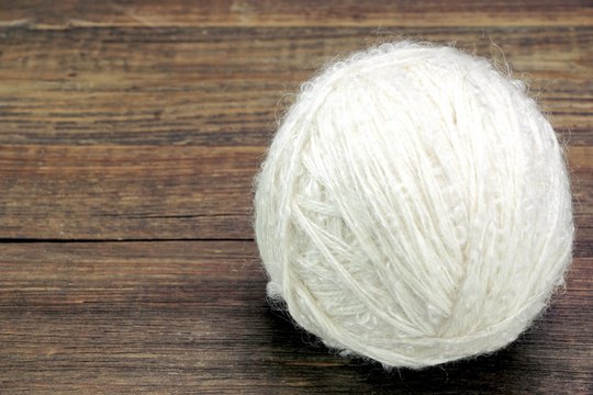 White Wool Roll On Wood Background
