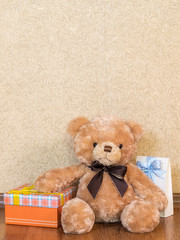 Soft toy and gift boxes on the wooden floor