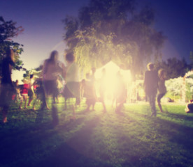 Fototapeta premium people mingling at a free concert by musicians in a garden