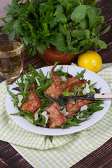 Grilled bacon with parmesan cheese and arugula