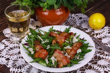 Grilled bacon with parmesan cheese and arugula